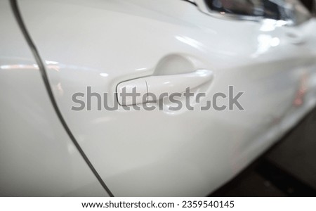 Focus on door of white expensive sportcar with keyless system used for ensuring high level of security against automobile thieves and criminals on high-tech auto model. Low risk concept