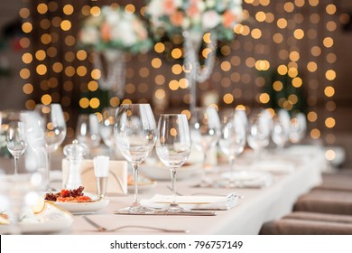 focus on glasses. Banquet table in the restaurant, the preparation before the banquet. the work of professional florists. - Shutterstock ID 796757149