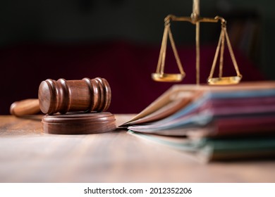 focus on hammer, group of files on judge table covered with dust - concept of pending old cases or work at judicial court. - Shutterstock ID 2012352206