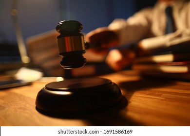 Focus On Judge Utility On Wooden Table Used To Maintain Order And Pronounce A Verdict In Courtroom In Front Of Many People. Rule Of Law And Strict Court Concept