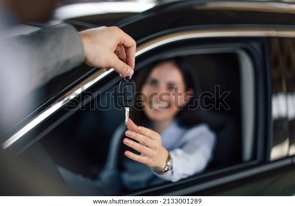 Focus on the key,\
woman getting a car key.