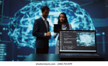 Focus on laptop in workspace used by AI researchers working with artificial intelligence in blurry background. Close up of notebook used by employees developing AI systems in tech startup, camera B - Powered by Shutterstock