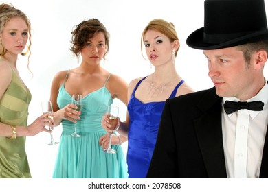 Focus On Man.  Man In Tux With Three Beautiful Women In Background.