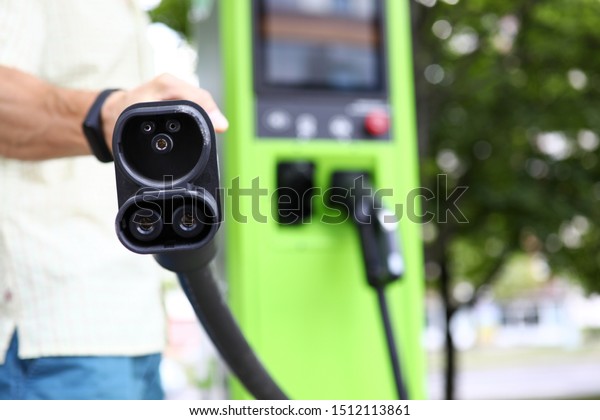 Focus on modern\
charge device for automobile. Auto filling station for electro\
vehicle. Environmental protection and newest transport technology\
concept. Blurred\
background
