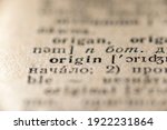 focus on origin word printed inside vintage dictionary