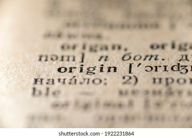 focus on origin word printed inside vintage dictionary