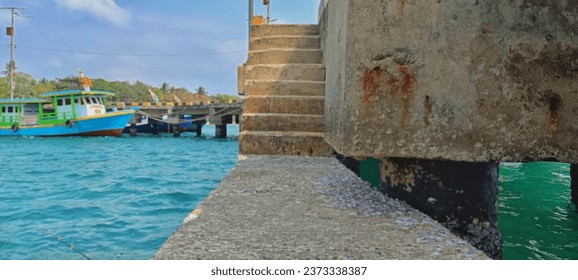 focus on the pier stairs. In my opinion, this pier was made specifically for the people of Sebesi Island. They live without adequate electricity and they live mostly as fishermen. This photo was taken