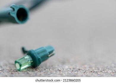 Focus on replacement bulb for a string of Christmas lights to repair a dud.  - Shutterstock ID 2123860205