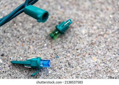 Focus on replacement bulb for a string of Christmas lights to repair a dud.  - Shutterstock ID 2138537583