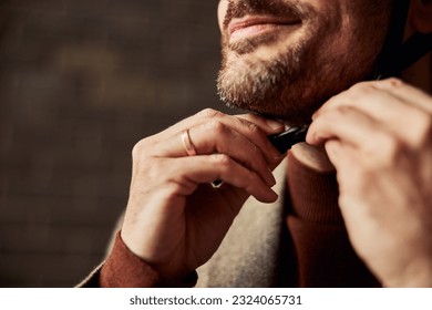 A focus on a smiling bearded businessman, adjusting a helmet for a bicycle ride. - Powered by Shutterstock