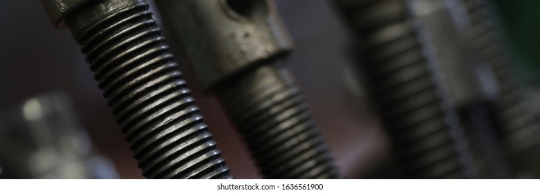 Focus on special metal details consisting of screws, steel bolts, nuts, nails and rivets used in big modern factory. Manual manufacturing process concept