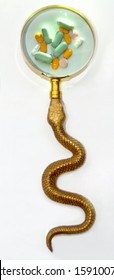 Focus On Tablets In Golden Magnify Glass With Snake.