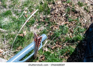 Focus On Top Of A Steel Fence Post With The Blurred Driver Laying On The Ground