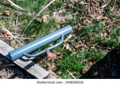 Focus On Top Of A Steel Fence Post With The Blurred Driver Laying On The Ground