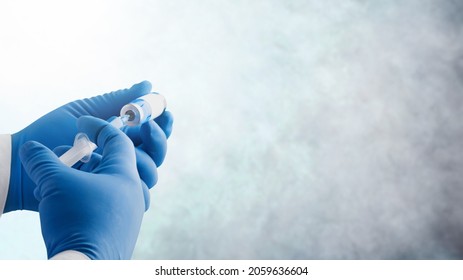 Focus on vaccine, doctor or nurse hands taking covid vaccination booster shot - Shutterstock ID 2059636604