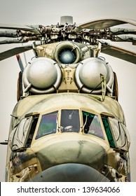 Focus On Windows Of Cockpit And Propeller Of Russian Military Helicopter, Gray Sky In Background. Army Air Transport In Russia. Front View Of Chopper Outdoors. Modern, Beautifully Designed Helicopter.