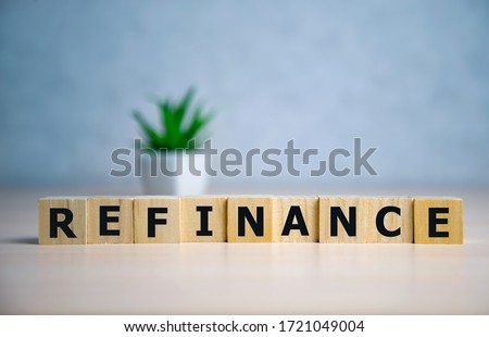 focus on wooden blocks with letters Refinance text. Concept image.