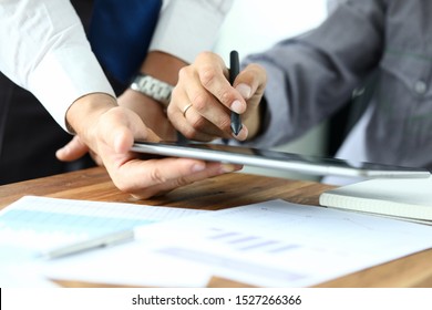 Focus on workers hands holding tablet. Manager giving for signature e-documents. Director signing important contract. Business concept. Blurred background