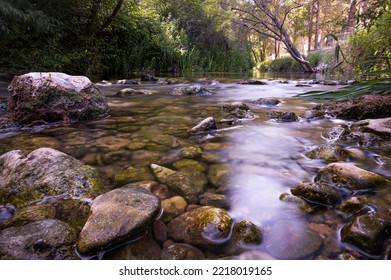 In Focus Rocks In The Clear Riverbed, Long Exposure, Purple Tones