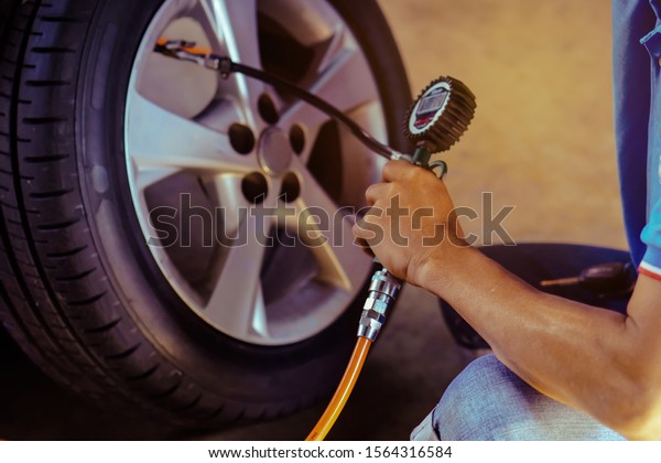Focus selection: checking tire pressure\
and checking air pressure with a pressure\
gauge