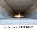 Focus stacked image inside a concrete box culvert under a road for stormwater drainage. 