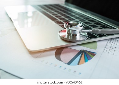 Focus Stethoscope Doctor table on laptop computer with report analysis and money about Healthcare costs and fees in medical hostpital office. Healthcare budget and business concept - Powered by Shutterstock