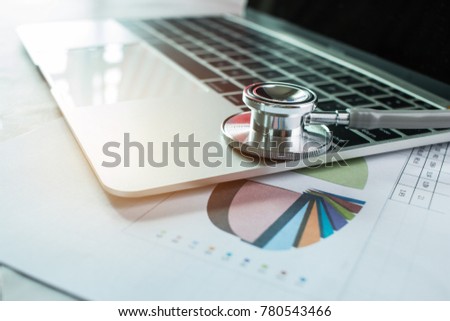 Focus Stethoscope Doctor table on laptop computer with report analysis and money about Healthcare costs and fees in medical hostpital office. Healthcare budget and business concept
