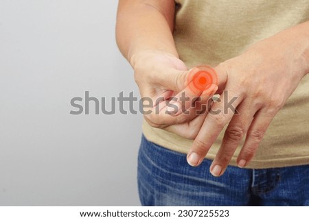 Focus of woman finger suffering from knuckle pain on white background. Healthcare and office syndrome concept.