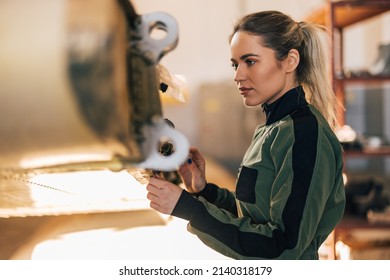 Focused adult woman, making sure the plane is ready, checking everything. - Powered by Shutterstock