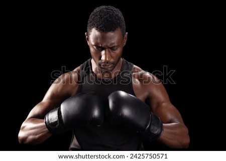 Focused African American boxer prepares for a match, with copy space. His intense gaze and stance exude determination and strength.