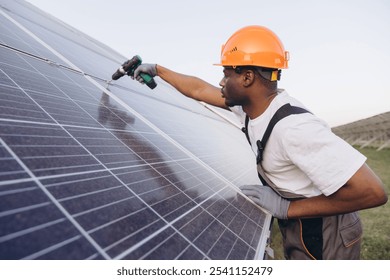 A focused African American engineer inspects solar panels using drill, symbolizing renewable energy and sustainable technology. The clear sky enhances scene, highlighting the significance. - Powered by Shutterstock