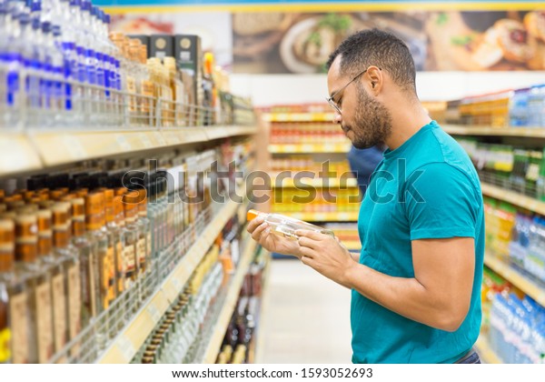 Focused African American Man Holding Alcohol Stock Photo (Edit Now) 1593052693