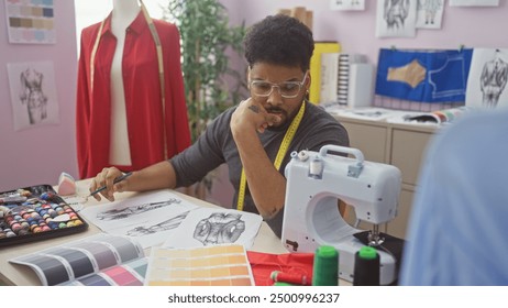 Focused african man sewing at his tailor shop, surrounded by fabric swatches and fashion sketches. - Powered by Shutterstock