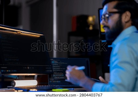 Focused AI software developer deep-diving into complex deep learning model training, ensuring precision and accuracy in algorithmic data outputs.