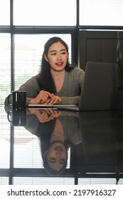 Focused Asian Woman Looking At Computer Tablet While Studying Online On Web Virtual Class At Home