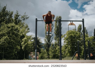 Focused athlete performing pull-ups at an outdoor fitness station in a sunlit urban park, showcasing strength and endurance. - Powered by Shutterstock