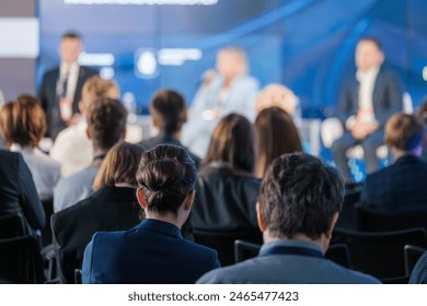 Focused audience listening to speakers at a business conference panel discussion. Event promotes networking and professional development opportunities. - Powered by Shutterstock