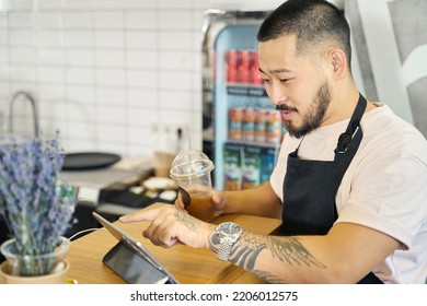 Focused Brunette Coffee Shop Worker Making A Payment Receipt