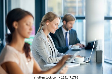 Focused Business Woman Sitting At Her Desk And Working