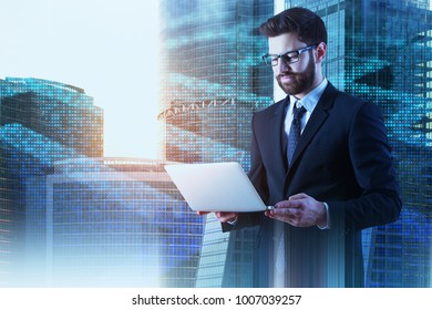 Focused Businessman Using Laptop On Abstract City Background With Digital Maze. Technology And Challenge Concept. Double Exposure 