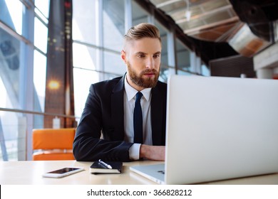 Focused businessman working on laptop in the office - Shutterstock ID 366828212