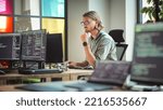 Focused Caucasian Man Coding On Desktop Computer in Stylish Office Space. Male Software Engineer Developing Innovative Application For Business Customers in Technological Start-up Company.