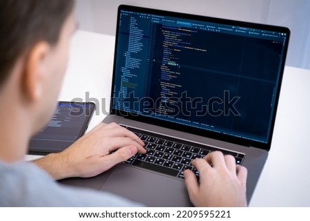Focused and concentrated guy that coding on his laptop, programmer at work, online jobs, work from home, Frontend developer, software development, computer