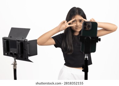 Focused content creator adjusting camera near studio lights at this exact curren