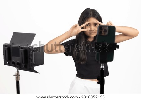 Focused content creator adjusting camera near studio lights at this exact curren