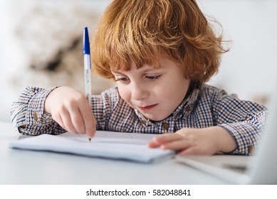 Focused Diligent Child Writing An Essay