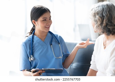 Focused doctor in glasses write diagnosis symptoms of mature woman patient in medical case. - Shutterstock ID 2255767703