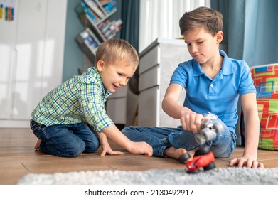 Focused Elder Brother Entertaining His Younger Sibling