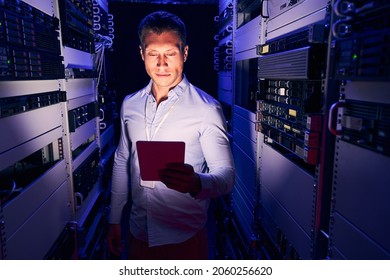 Focused IT Engineer With Gadget In Server Room