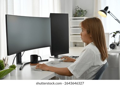 Focused female programmer writing code at a desk with dual monitors and a modern workspace. - Powered by Shutterstock - Get 15% off with code: PIKWIZARD15